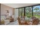 Sunroom with glass sliding doors and wicker furniture at 153 Wild Palm Dr # 153, Bradenton, FL 34210