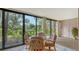 Sunroom with glass sliding doors and wicker furniture at 153 Wild Palm Dr # 153, Bradenton, FL 34210