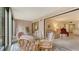 Bright sunroom with glass table and wicker chairs, offering access to the outdoors at 153 Wild Palm Dr # 153, Bradenton, FL 34210