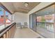 Private balcony with seating area and pool view at 1618 Stickney Point Rd # 1618-202, Sarasota, FL 34231