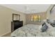 King bedroom with updated flooring, ceiling fan, and lots of natural light at 1618 Stickney Point Rd # 1618-202, Sarasota, FL 34231