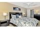 King bedroom with updated flooring, ceiling fan, and lots of natural light at 1618 Stickney Point Rd # 1618-202, Sarasota, FL 34231