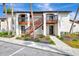 Condo building exterior with stairs and landscaping at 1618 Stickney Point Rd # 1618-202, Sarasota, FL 34231