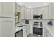 Modern white kitchen with stainless steel appliances at 1618 Stickney Point Rd # 1618-202, Sarasota, FL 34231