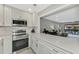 Modern kitchen with view into living room at 1618 Stickney Point Rd # 1618-202, Sarasota, FL 34231