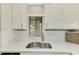 Modern kitchen sink with white cabinets and quartz countertop at 1618 Stickney Point Rd # 1618-202, Sarasota, FL 34231