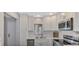 Updated kitchen with stainless steel appliances and white cabinets at 1618 Stickney Point Rd # 1618-202, Sarasota, FL 34231