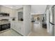 Open kitchen with white cabinets and stainless steel appliances at 1618 Stickney Point Rd # 1618-202, Sarasota, FL 34231