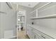 Convenient laundry room with white cabinets and quartz countertops at 1618 Stickney Point Rd # 1618-202, Sarasota, FL 34231