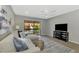 Living area featuring a sectional sofa and a large TV, with access to a patio at 1618 Stickney Point Rd # 1618-202, Sarasota, FL 34231