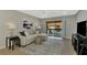 Living room with sectional sofa, sliding glass doors, and a view of the pool at 1618 Stickney Point Rd # 1618-202, Sarasota, FL 34231