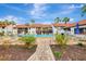 Community pool area with lounge chairs and patio at 1618 Stickney Point Rd # 1618-202, Sarasota, FL 34231