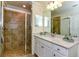 Bathroom with shower, vanity, and large mirror at 17520 Gawthrop Dr # 102, Bradenton, FL 34211