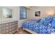 Bright bedroom with a full-size bed and dresser at 17520 Gawthrop Dr # 102, Bradenton, FL 34211