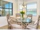 Bright dining area with glass table and wicker chairs, offering scenic views at 17520 Gawthrop Dr # 102, Bradenton, FL 34211