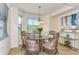 Elegant dining area with a glass table and wicker chairs at 17520 Gawthrop Dr # 102, Bradenton, FL 34211