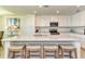 Modern kitchen with white cabinets, quartz counters, and island at 17520 Gawthrop Dr # 102, Bradenton, FL 34211