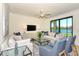 Spacious living room with lake views and modern furniture at 17520 Gawthrop Dr # 102, Bradenton, FL 34211