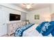 Main bedroom with king bed, TV, dresser, and access to bathroom at 17520 Gawthrop Dr # 102, Bradenton, FL 34211