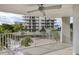 Balcony with partial ocean view and surrounding building views at 1770 Benjamin Franklin Dr # 204, Sarasota, FL 34236