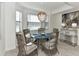 Bright dining room with a glass-top table and wicker chairs at 17724 Gawthrop # 103, Bradenton, FL 34211