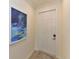 Bright condo entry with white door and artwork on the wall at 17724 Gawthrop # 103, Bradenton, FL 34211