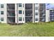 Building exterior with screened balconies and lush landscaping at 17724 Gawthrop # 103, Bradenton, FL 34211