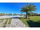 Landscaped pool area with a walkway, palm trees and waterfall feature at 17724 Gawthrop # 103, Bradenton, FL 34211