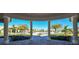 View of resort-style pool and palm trees from covered walkway at 17724 Gawthrop # 103, Bradenton, FL 34211