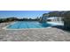 Large resort-style pool with a waterfall and plenty of lounge chairs at 17724 Gawthrop # 103, Bradenton, FL 34211