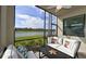 Screened porch with comfy seating and scenic pond view at 17724 Gawthrop # 103, Bradenton, FL 34211