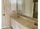 Bathroom with double vanity and mirrored medicine cabinet at 1803 Ashley Dr, Venice, FL 34292