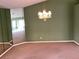 Dining area with a chandelier and mirrored accent wall at 1803 Ashley Dr, Venice, FL 34292