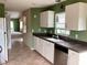 Kitchen with white cabinets, stainless steel appliances, and tile flooring at 1803 Ashley Dr, Venice, FL 34292