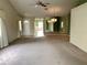 Bright and airy living room with mirrored wall and carpet flooring at 1803 Ashley Dr, Venice, FL 34292
