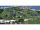 Aerial view of the expansive golf course, clubhouse, and surrounding area at 240 Sands Point Rd # 4201, Longboat Key, FL 34228
