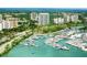 Aerial perspective of a coastal city featuring a marina and high-rises at 240 Sands Point Rd # 4201, Longboat Key, FL 34228