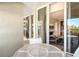 Glass-door balcony with table and chairs; living room view at 240 Sands Point Rd # 4201, Longboat Key, FL 34228