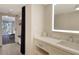 Bathroom with a modern vanity and illuminated mirror at 240 Sands Point Rd # 4201, Longboat Key, FL 34228