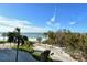 Panoramic beach view; ocean and palm trees at 240 Sands Point Rd # 4201, Longboat Key, FL 34228