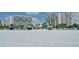 Beachfront view of resort community with white sand and condo buildings at 240 Sands Point Rd # 4201, Longboat Key, FL 34228