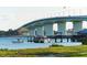 View of a bridge over the water with boats and a dock at 240 Sands Point Rd # 4201, Longboat Key, FL 34228