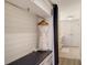 White-walled closet with bench, robe, and hanging rod at 240 Sands Point Rd # 4201, Longboat Key, FL 34228