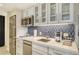 Modern kitchen with stainless steel appliances and blue tile backsplash at 240 Sands Point Rd # 4201, Longboat Key, FL 34228
