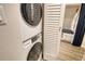 Stackable white washer and dryer in laundry closet at 240 Sands Point Rd # 4201, Longboat Key, FL 34228