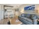 Living room with sofa and coffee table, open to kitchen area at 240 Sands Point Rd # 4201, Longboat Key, FL 34228