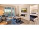 Bright living room with comfortable seating and access to balcony at 240 Sands Point Rd # 4201, Longboat Key, FL 34228