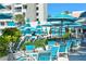 Relaxing pool deck area with teal umbrellas and lounge chairs at 240 Sands Point Rd # 4201, Longboat Key, FL 34228