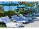 Comfortable lounge chairs with white towels await at the poolside at 240 Sands Point Rd # 4201, Longboat Key, FL 34228