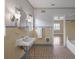 Retro bathroom with yellow tile and vintage vanity at 2425 Riverview Blvd, Bradenton, FL 34205
